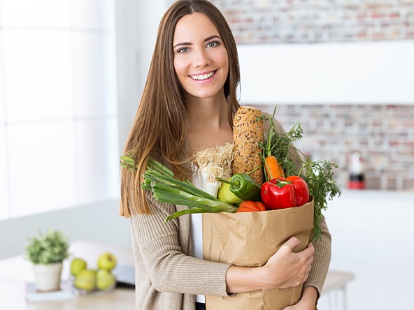 Woman holding bag of vegetables